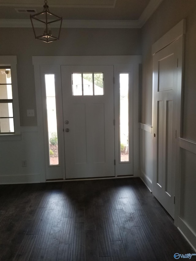 entryway featuring ornamental molding and dark hardwood / wood-style flooring