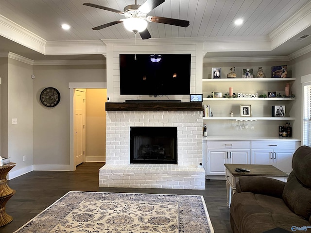 living room featuring wood ceiling, ceiling fan, dark hardwood / wood-style floors, a fireplace, and ornamental molding