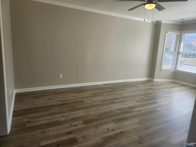 spare room featuring baseboards, ceiling fan, dark wood finished floors, ornamental molding, and a textured ceiling