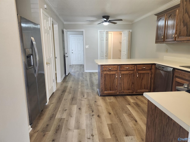 kitchen with light wood-type flooring, light countertops, dishwashing machine, a peninsula, and stainless steel fridge