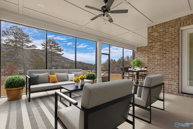 sunroom featuring ceiling fan