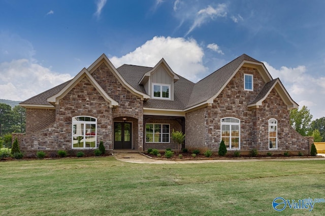 view of front of home with a front lawn and french doors