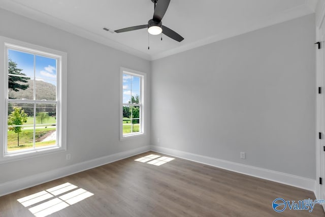 unfurnished room featuring hardwood / wood-style floors, ornamental molding, and ceiling fan