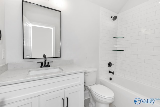 full bathroom featuring vanity, tiled shower / bath combo, and toilet