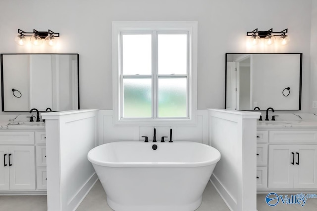 bathroom featuring vanity and a tub