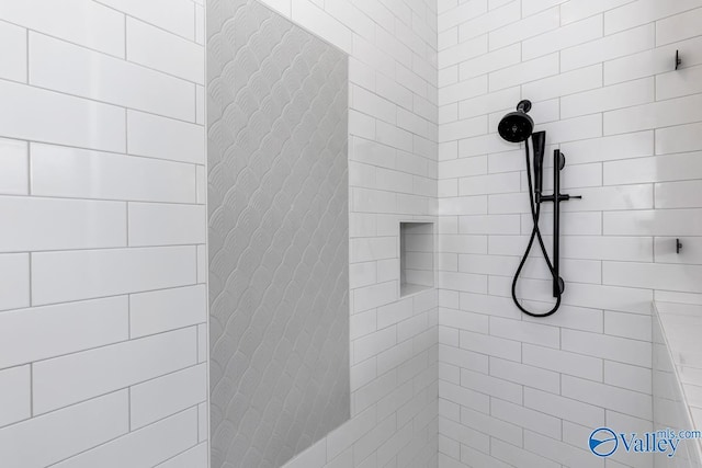 bathroom with tiled shower