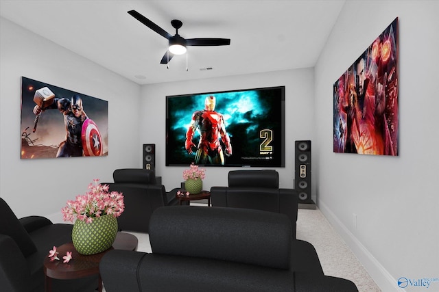 carpeted cinema room featuring ceiling fan