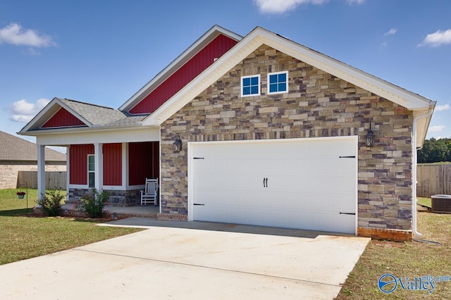 craftsman house with a garage, central AC unit, and a front yard