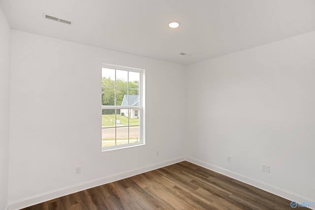 empty room with dark hardwood / wood-style floors