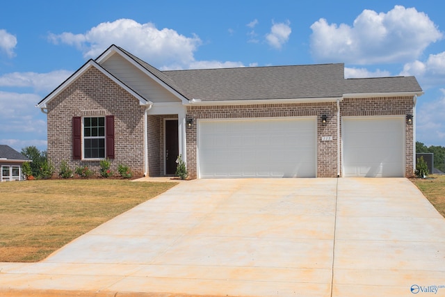 view of front of house featuring a garage and a front lawn