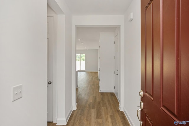 corridor with hardwood / wood-style floors