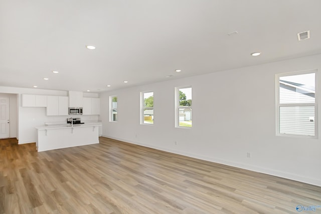 unfurnished living room with light wood-type flooring