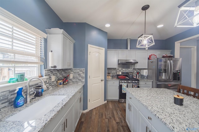 kitchen featuring sink, hanging light fixtures, stainless steel appliances, light stone countertops, and white cabinets