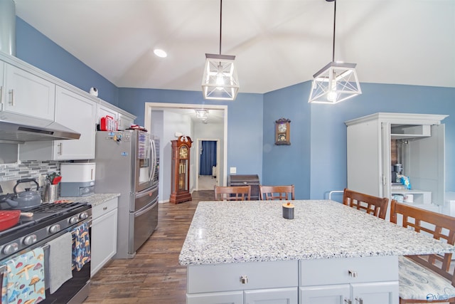 kitchen with hanging light fixtures, white cabinetry, appliances with stainless steel finishes, and a center island