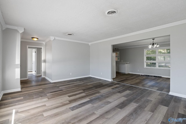 unfurnished living room featuring ornamental molding, a textured ceiling, a notable chandelier, and dark hardwood / wood-style floors