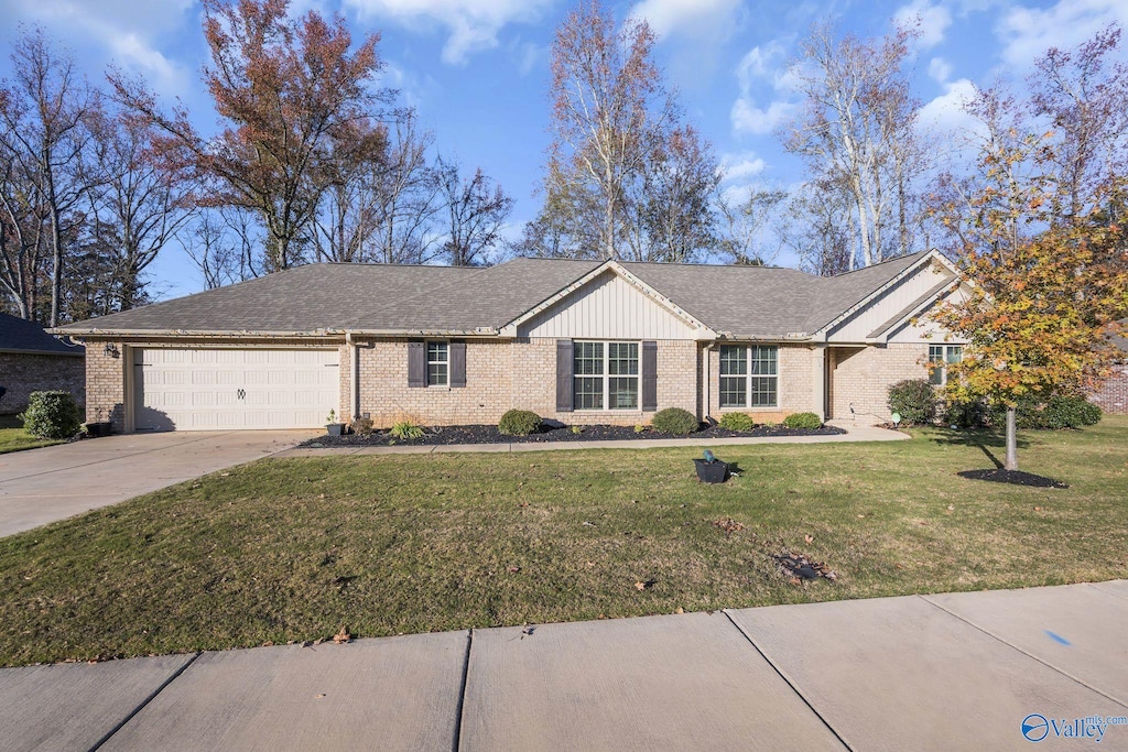 single story home with a front yard and a garage