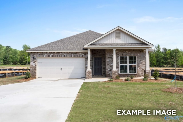 craftsman house with a garage and a front lawn