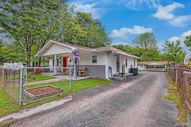 1213 Humes Ave NE, Huntsville, AL 35801 - view of front of house with fence, an outdoor structure, a detached garage, a porch, and a front lawn