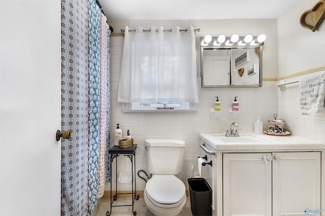 1213 Humes Ave NE, Huntsville, AL 35801 - bathroom with tile walls, toilet, curtained shower, and vanity
