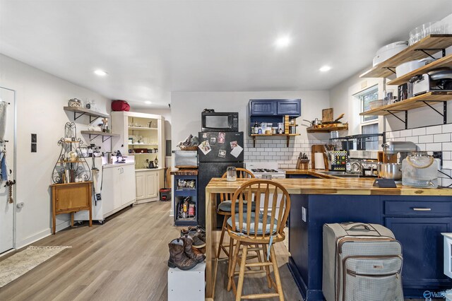 1213 Humes Ave NE, Huntsville, AL 35801 - interior space with recessed lighting, light wood finished floors, a sink, black microwave, and backsplash