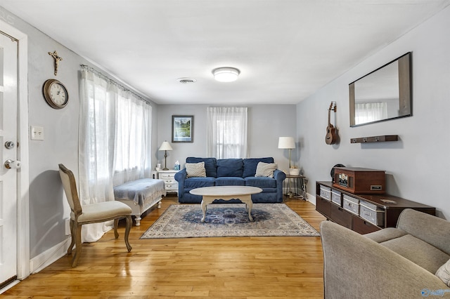 1213 Humes Ave NE, Huntsville, AL 35801 - living area featuring baseboards, visible vents, and wood finished floors