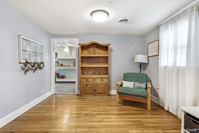 1213 Humes Ave NE, Huntsville, AL 35801 - living area with baseboards, light wood-style flooring, and visible vents