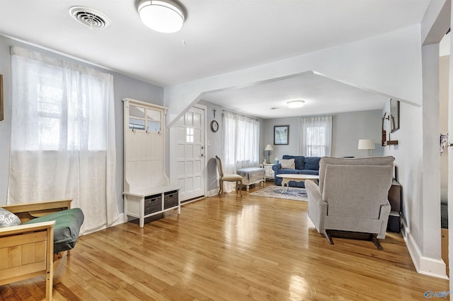 1213 Humes Ave NE, Huntsville, AL 35801 - living area featuring baseboards, light wood-style flooring, and visible vents