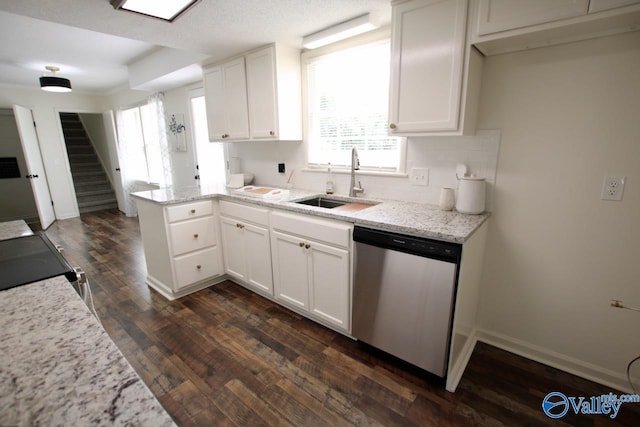 2520 Excalibur Dr SE, Huntsville, AL 35803 - kitchen with stainless steel dishwasher, a sink, white cabinetry, a peninsula, and dark wood-style flooring