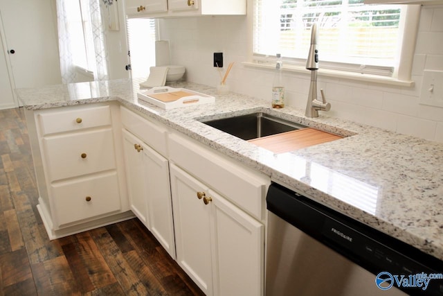 2520 Excalibur Dr SE, Huntsville, AL 35803 - kitchen featuring stainless steel dishwasher, a sink, backsplash, dark wood finished floors, and light stone counters