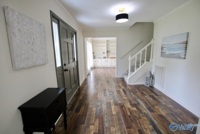 2520 Excalibur Dr SE, Huntsville, AL 35803 - hallway featuring stairway, dark wood finished floors, crown molding, and built in shelves