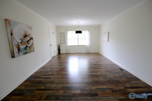 2520 Excalibur Dr SE, Huntsville, AL 35803 - spare room with crown molding, dark wood-style floors, and baseboards