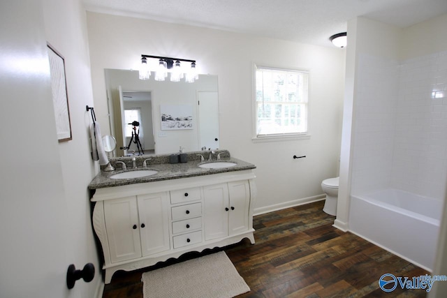 2520 Excalibur Dr SE, Huntsville, AL 35803 - full bath featuring toilet, double vanity, wood finished floors, and baseboards