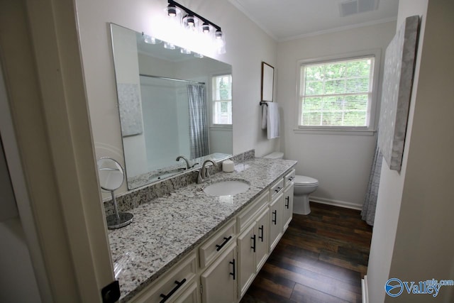 2520 Excalibur Dr SE, Huntsville, AL 35803 - bathroom featuring hardwood / wood-style floors, crown molding, toilet, vanity, and baseboards