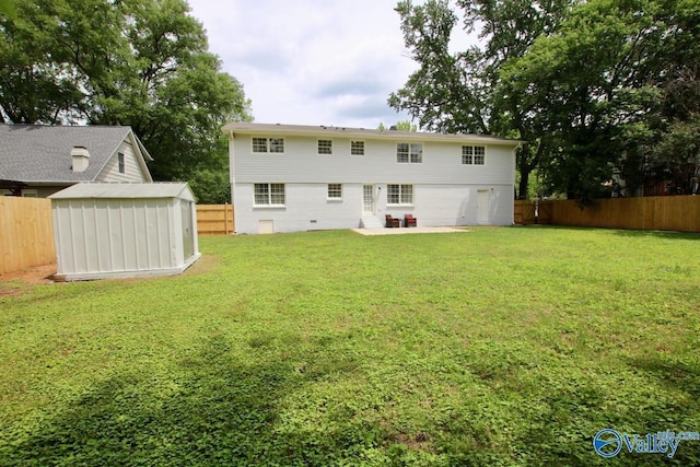 2520 Excalibur Dr SE, Huntsville, AL 35803 - rear view of property featuring a storage unit, a patio area, an outbuilding, and an attached garage