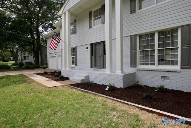 2520 Excalibur Dr SE, Huntsville, AL 35803 - view of side of home with brick siding, concrete driveway, a lawn, an attached garage, and crawl space