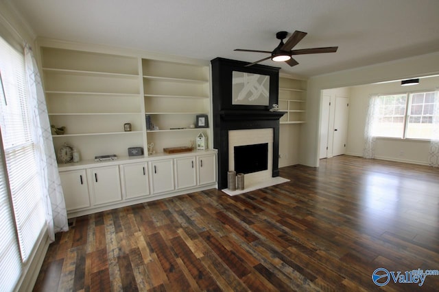 2520 Excalibur Dr SE, Huntsville, AL 35803 - unfurnished living room featuring ceiling fan, a fireplace, dark wood-style flooring, and ornamental molding