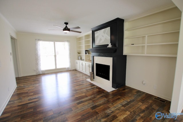 2520 Excalibur Dr SE, Huntsville, AL 35803 - unfurnished living room with a ceiling fan, a fireplace, ornamental molding, dark wood-style floors, and built in features
