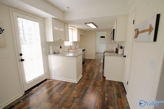 2520 Excalibur Dr SE, Huntsville, AL 35803 - kitchen featuring stainless steel appliances, a sink, dark wood-style flooring, white cabinets, and baseboards