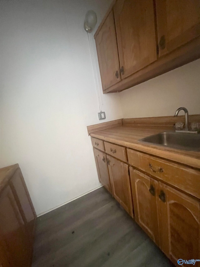 kitchen featuring sink and dark hardwood / wood-style flooring