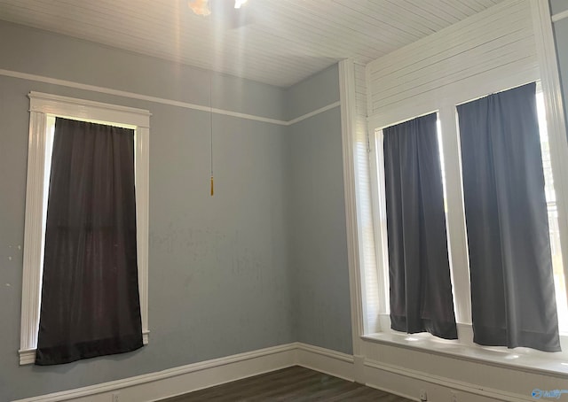 empty room with dark hardwood / wood-style flooring