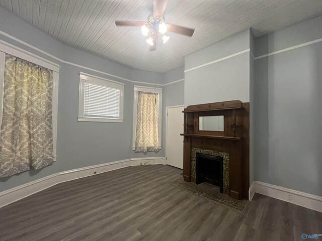 unfurnished living room featuring ceiling fan and dark wood-type flooring