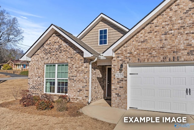 view of front of home with brick siding and an attached garage