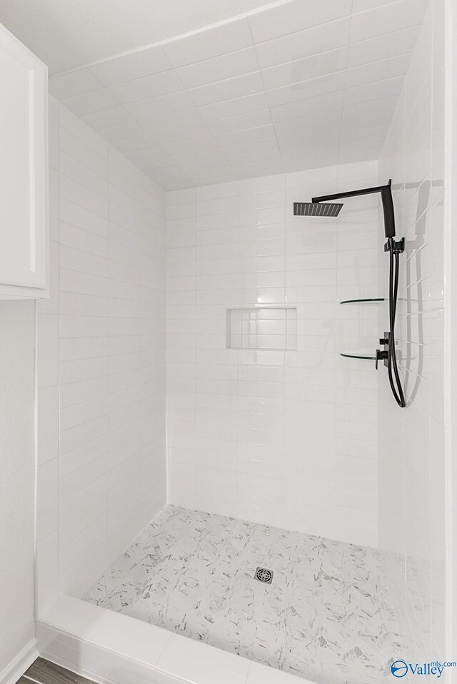 bathroom with tiled shower