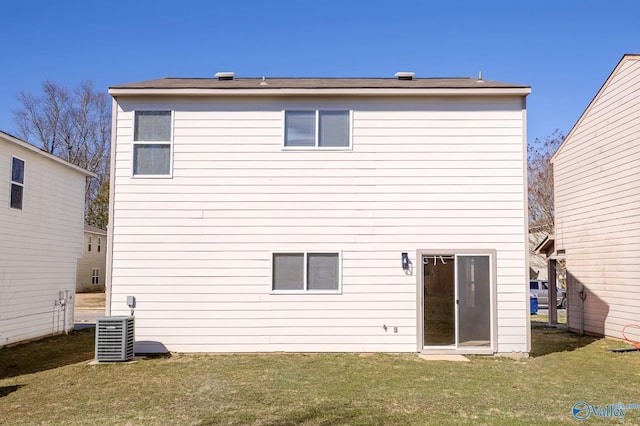 rear view of property featuring central AC and a yard