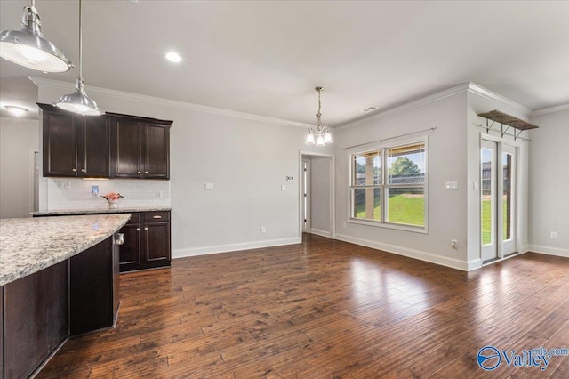 107 Duchess Dr, Madison, AL 35758 - kitchen with dark wood-style floors, pendant lighting, a chandelier, decorative backsplash, and dark brown cabinets