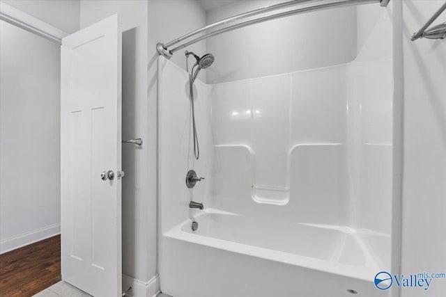 107 Duchess Dr, Madison, AL 35758 - bathroom with washtub / shower combination and wood finished floors