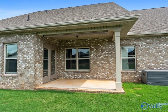 107 Duchess Dr, Madison, AL 35758 - back of house featuring a shingled roof, brick siding, and a patio