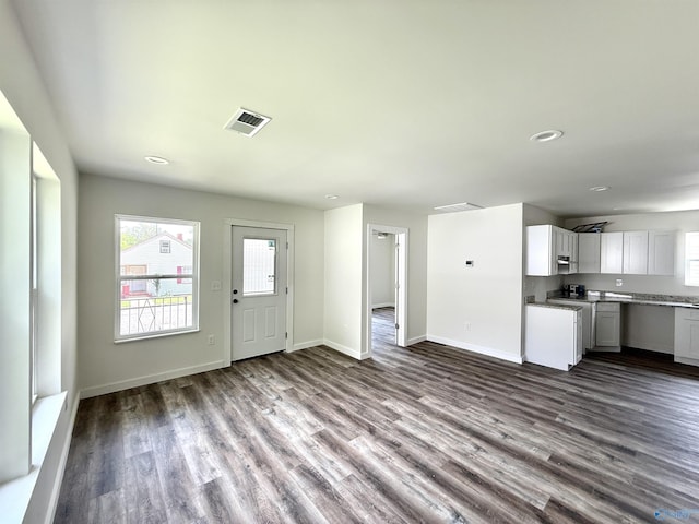 42 Wilkinson Ave E, Gadsden, AL 35904 - unfurnished living room with dark wood-type flooring, baseboards, and recessed lighting
