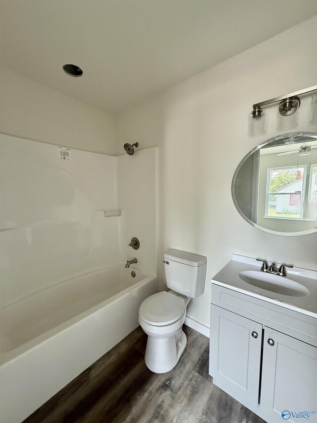 42 Wilkinson Ave E, Gadsden, AL 35904 - bathroom featuring toilet, vanity, wood finished floors, and shower / washtub combination