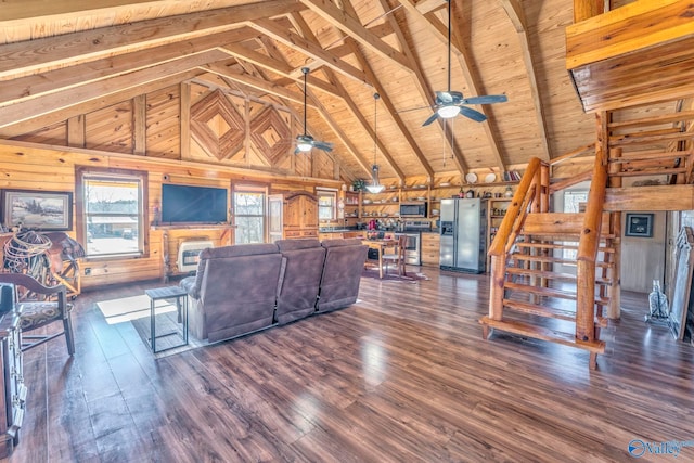 living room with dark hardwood / wood-style flooring, wood ceiling, wood walls, and beamed ceiling